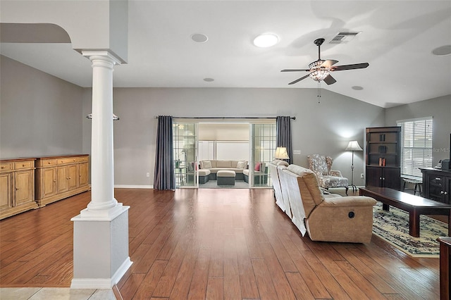 living room with ceiling fan, wood-type flooring, ornate columns, and vaulted ceiling