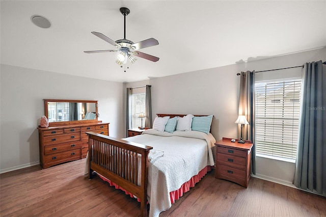 bedroom with ceiling fan and hardwood / wood-style flooring