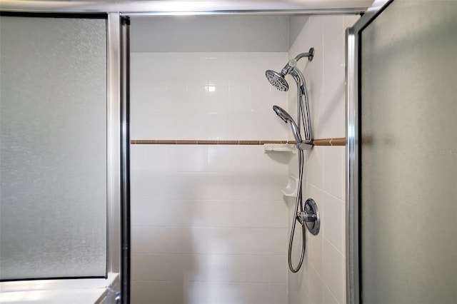 bathroom featuring a shower with door