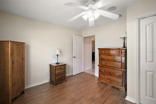 bedroom with ceiling fan and dark hardwood / wood-style floors