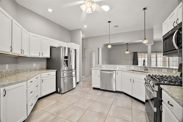 kitchen featuring appliances with stainless steel finishes, sink, white cabinets, kitchen peninsula, and hanging light fixtures