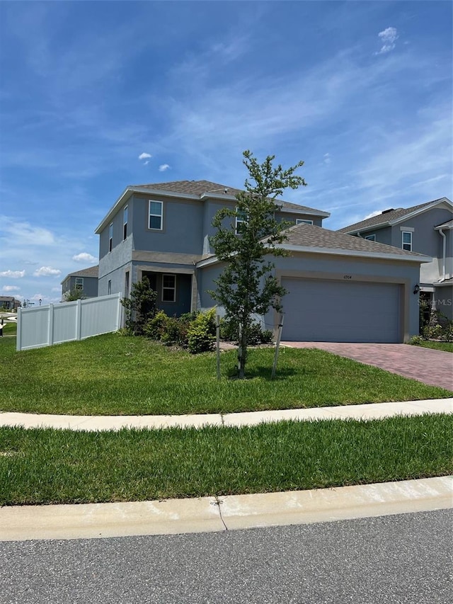 view of front of property featuring a front lawn and a garage