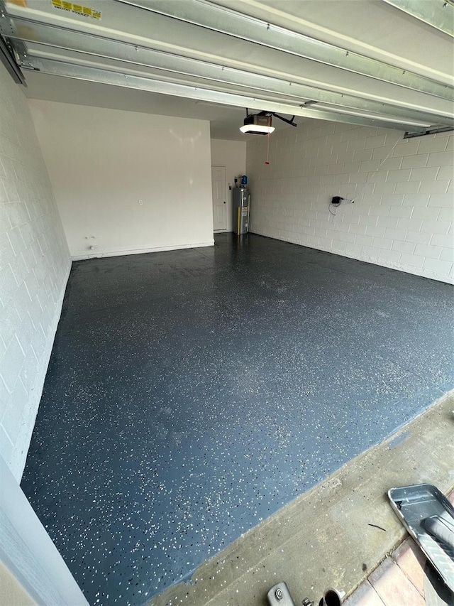 garage with electric water heater and a garage door opener