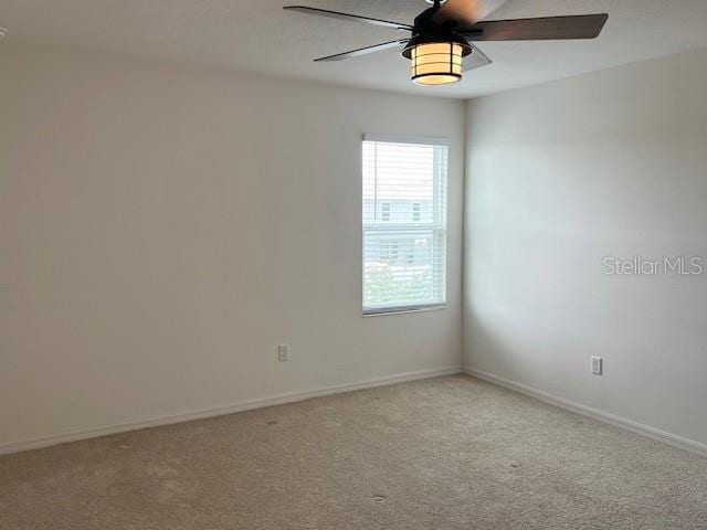 unfurnished room with ceiling fan and light colored carpet