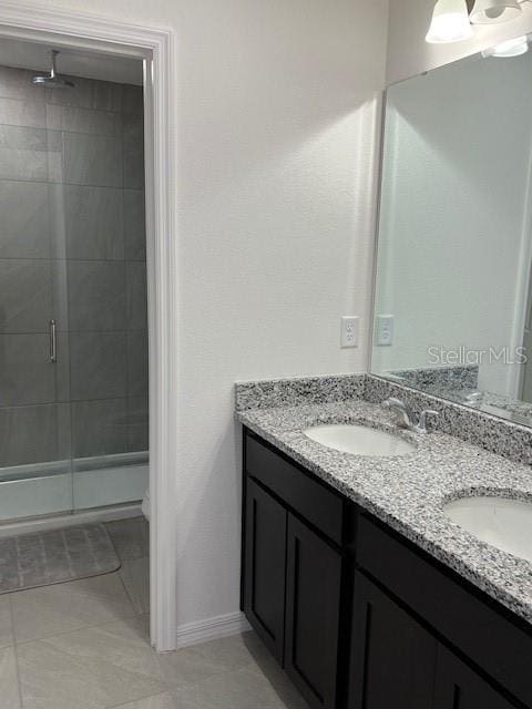 bathroom with walk in shower, vanity, toilet, and tile patterned floors