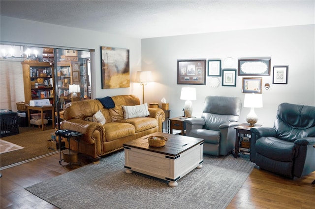 living room featuring dark wood-type flooring and a textured ceiling