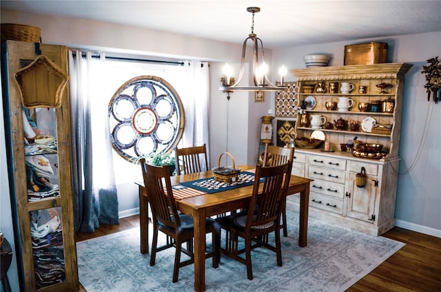 dining area featuring dark hardwood / wood-style flooring and a chandelier