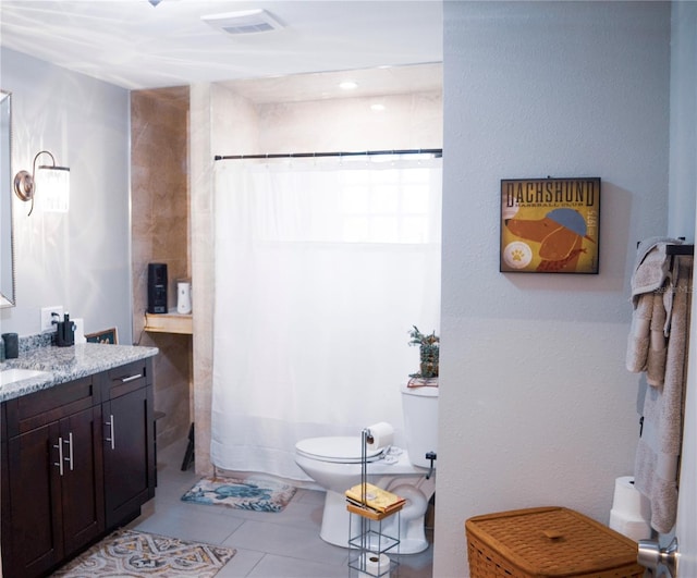 bathroom with toilet, tile patterned flooring, walk in shower, and vanity