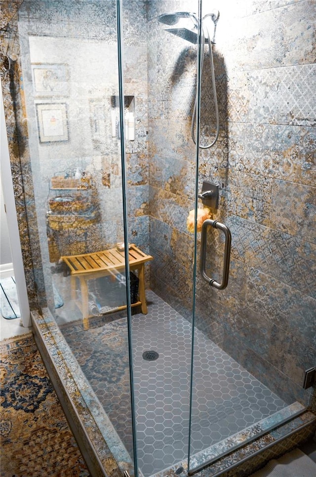 bathroom featuring a shower with shower door