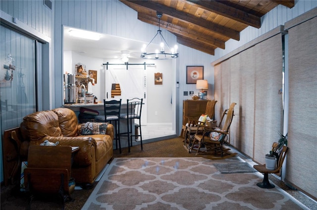 carpeted living room with a barn door, vaulted ceiling with beams, a chandelier, and wooden ceiling