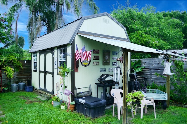 view of outdoor structure featuring a lawn