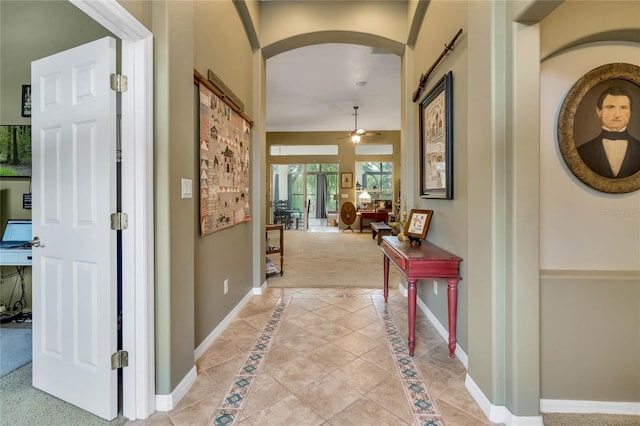 hallway featuring light carpet