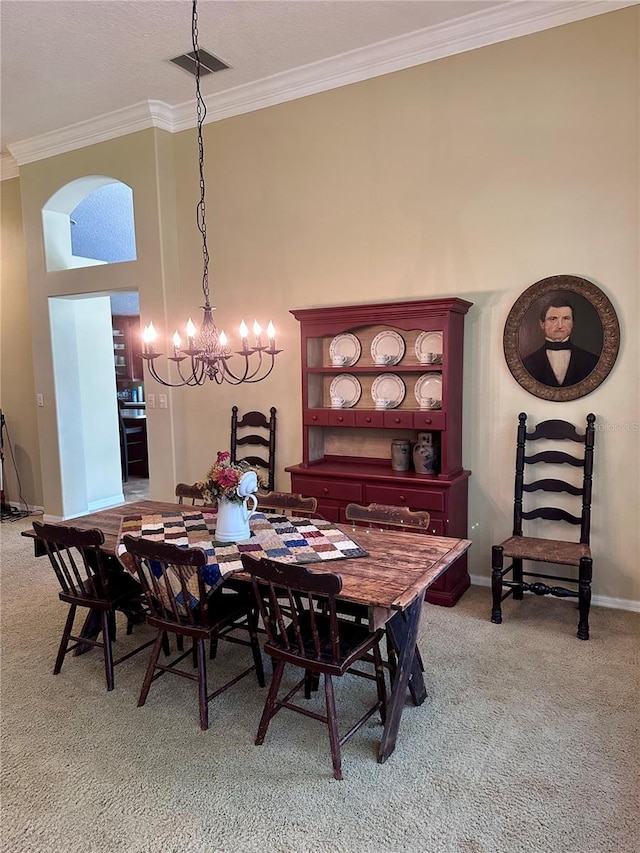 carpeted dining space featuring crown molding, a chandelier, and a high ceiling