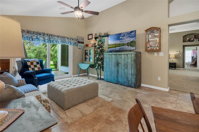 carpeted living room featuring high vaulted ceiling and ceiling fan