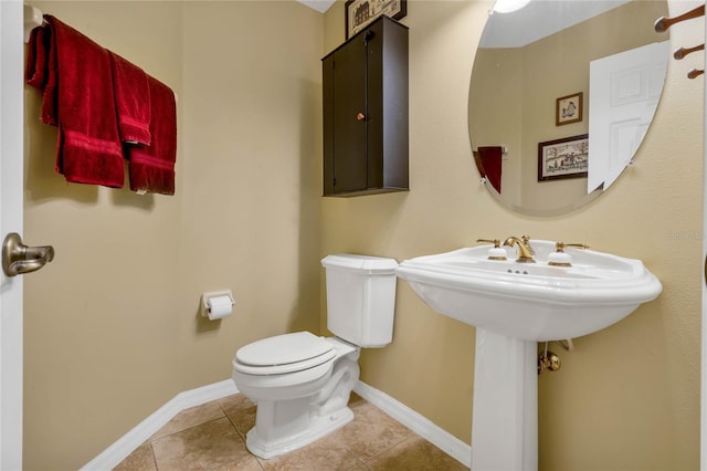 bathroom with toilet and tile patterned floors