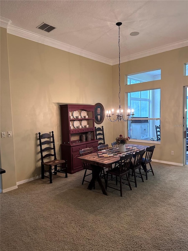 carpeted dining space with crown molding, a textured ceiling, and a chandelier