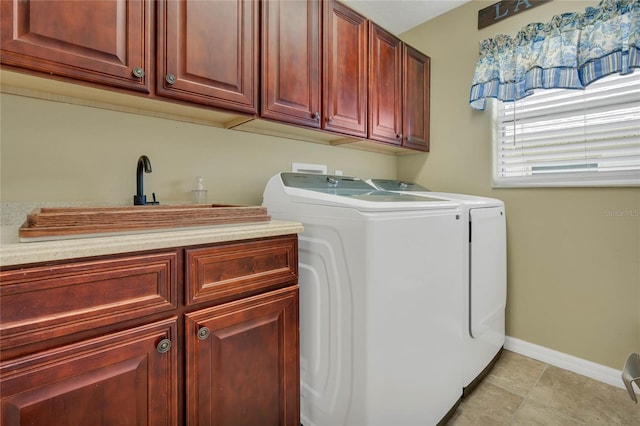 washroom featuring sink, washer and clothes dryer, light tile patterned flooring, and cabinets