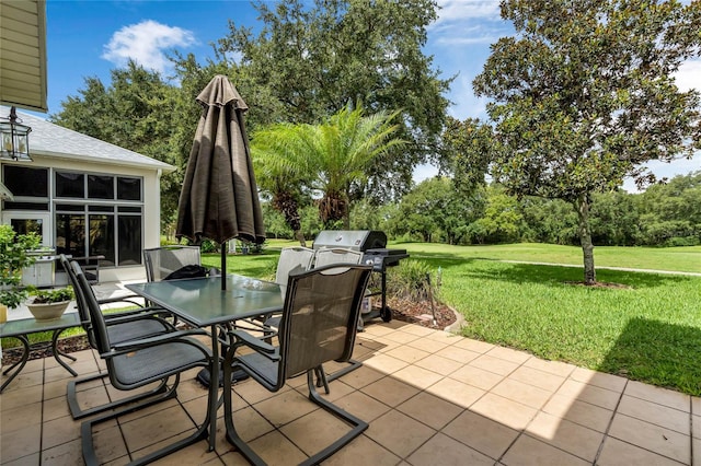 view of patio featuring a grill and a sunroom