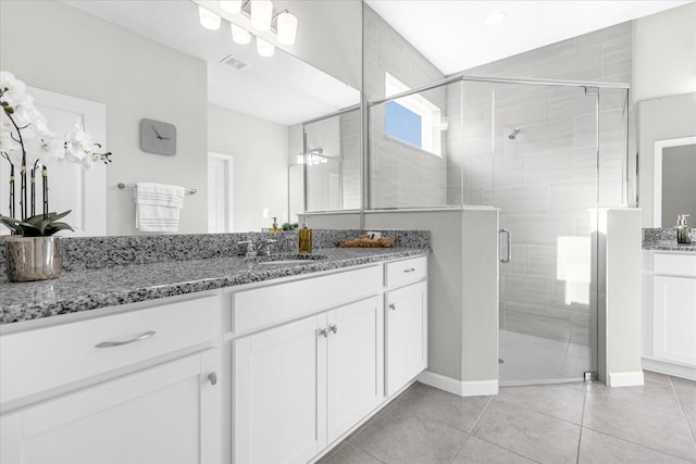 bathroom featuring ceiling fan, tile patterned floors, an enclosed shower, and vanity