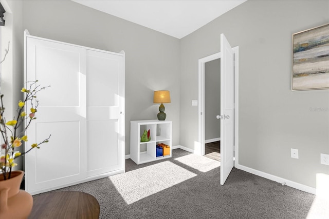 interior space featuring dark colored carpet