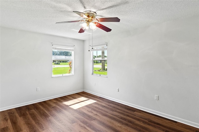 spare room featuring a textured ceiling, dark hardwood / wood-style floors, and ceiling fan