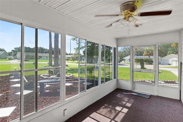 unfurnished sunroom with plenty of natural light and ceiling fan