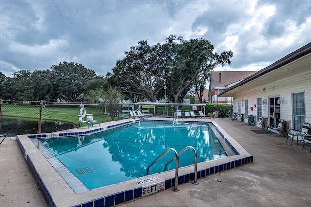 view of swimming pool with a patio