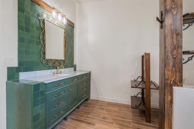 bathroom featuring wood tiled floor, baseboards, and vanity