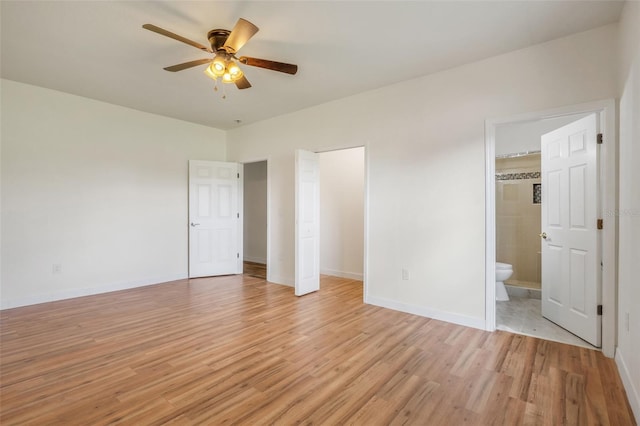 unfurnished bedroom with baseboards, ensuite bathroom, a ceiling fan, and light wood-style floors