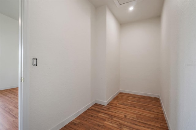 hall featuring recessed lighting, wood finished floors, and baseboards