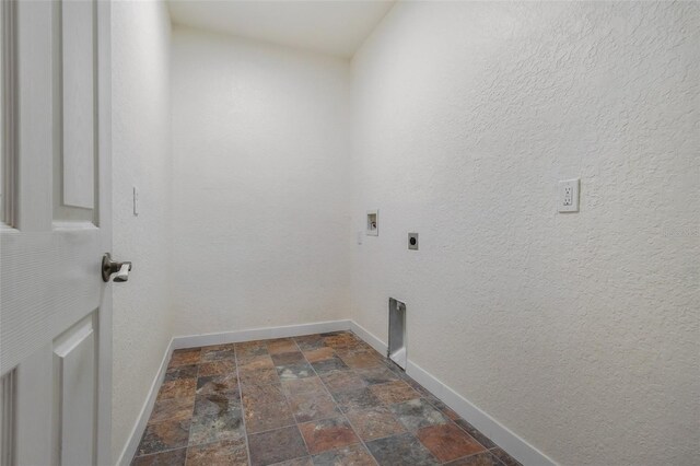 washroom with laundry area, hookup for an electric dryer, stone finish flooring, and baseboards