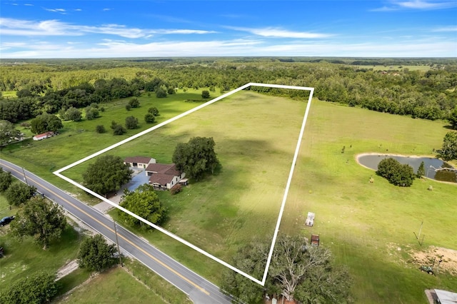 aerial view with a wooded view and a rural view