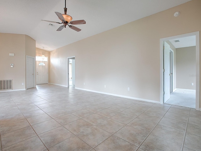 unfurnished room with ceiling fan, light tile patterned flooring, and lofted ceiling