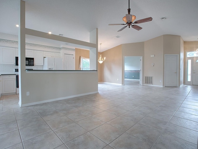 unfurnished living room with light tile patterned floors, plenty of natural light, and ceiling fan with notable chandelier