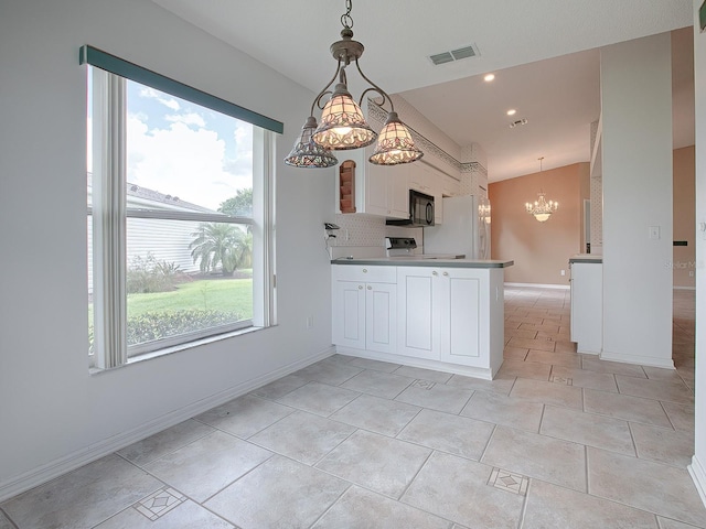 kitchen featuring kitchen peninsula, hanging light fixtures, a chandelier, range, and white cabinets