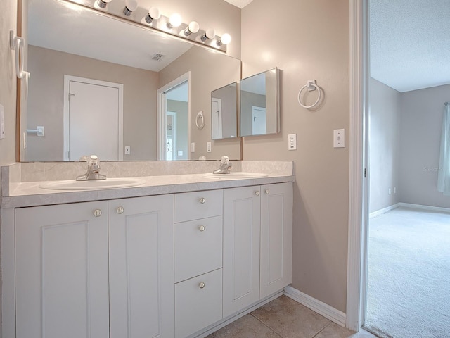 bathroom with vanity and a textured ceiling