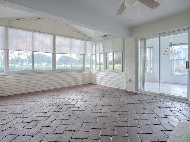 unfurnished sunroom featuring ceiling fan, a wealth of natural light, and lofted ceiling