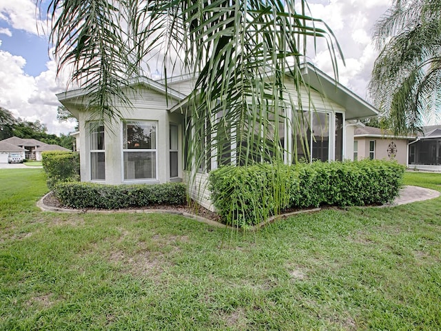 view of side of property with a lawn