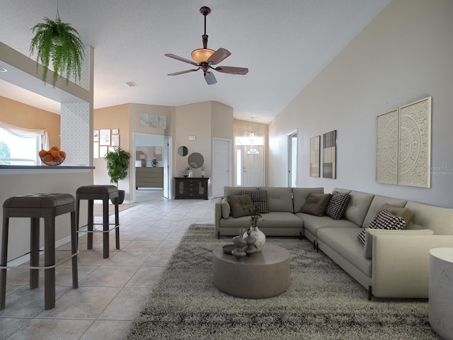 living room featuring high vaulted ceiling, light tile patterned floors, ceiling fan, and a textured ceiling