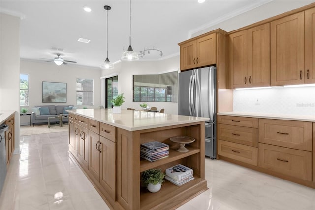 kitchen featuring tasteful backsplash, a kitchen island, pendant lighting, crown molding, and stainless steel fridge