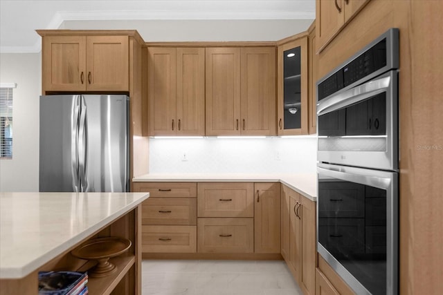 kitchen featuring backsplash, ornamental molding, and stainless steel appliances