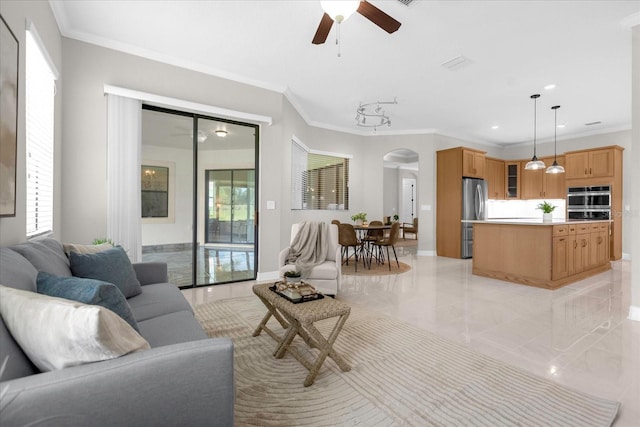 living room featuring ornamental molding and ceiling fan