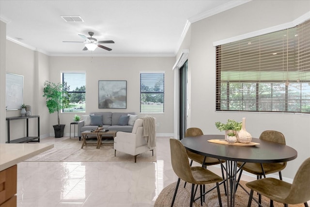 interior space with ceiling fan and ornamental molding