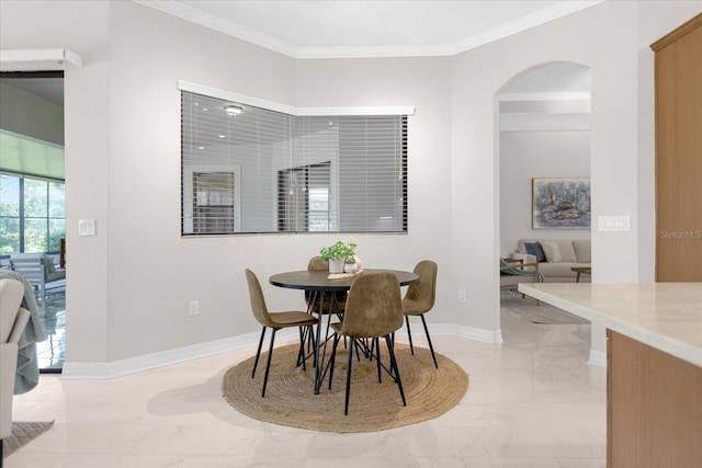 dining space featuring crown molding