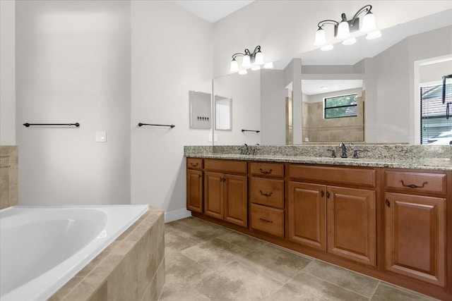 bathroom with vanity and tiled tub