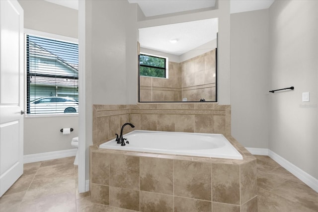 bathroom with toilet, tile patterned flooring, and plus walk in shower