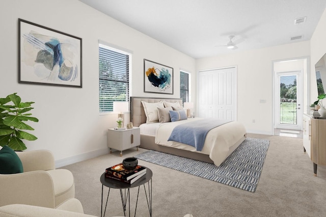 carpeted bedroom featuring ceiling fan and a closet