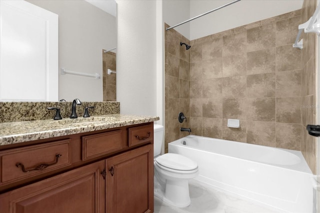 full bathroom with toilet, tiled shower / bath combo, and vanity