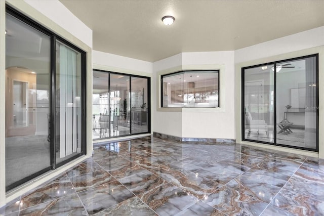 unfurnished room with a textured ceiling