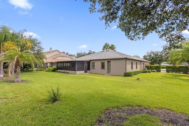 back of house with a lawn and a sunroom